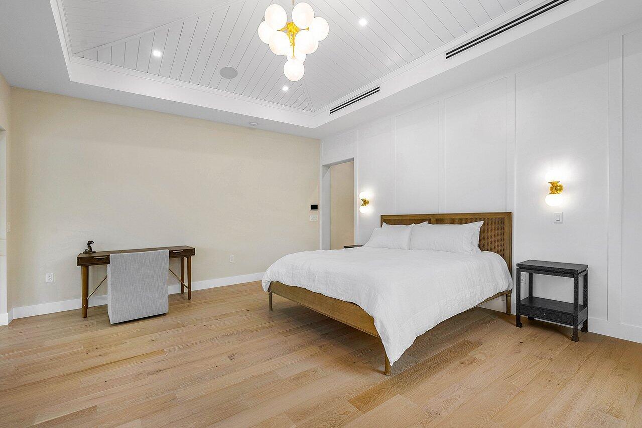 909 Bond Way Delray Beach, FL 33483 - Photo 34 of 43 a bedroom with a bed and a chair