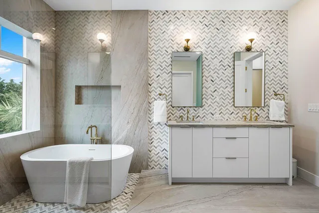 a bathroom with a tub sink and mirror