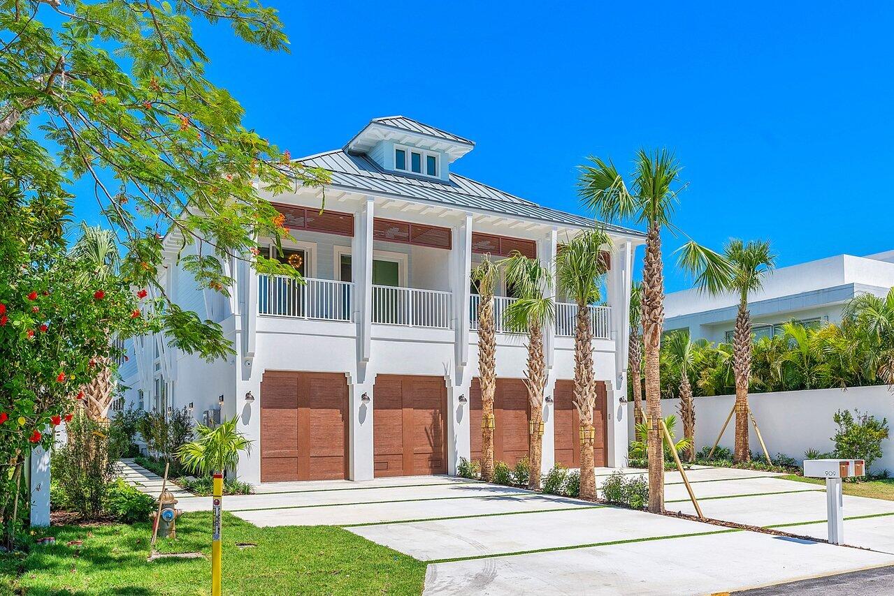 909 Bond Way Delray Beach, FL 33483 - Photo 4 of 43 a front view of a house with a garden