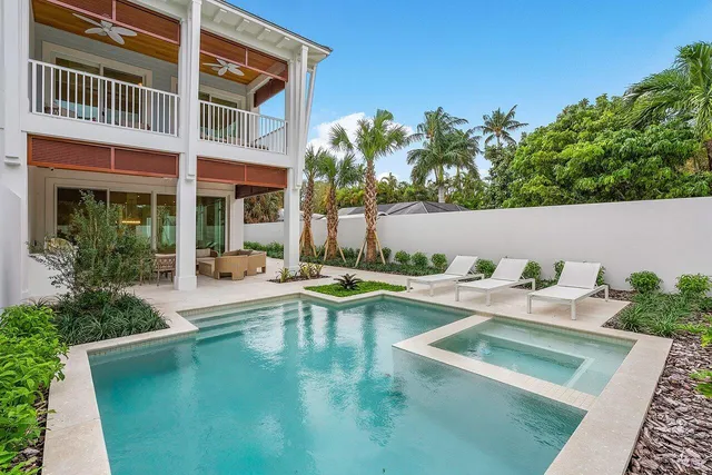 a view of swimming pool with outdoor seating and plants