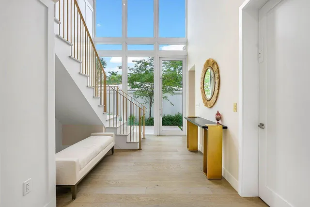 a view of entryway and hall with wooden floor