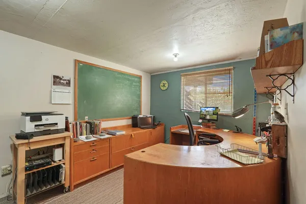 a room with furniture a flat screen tv and a window