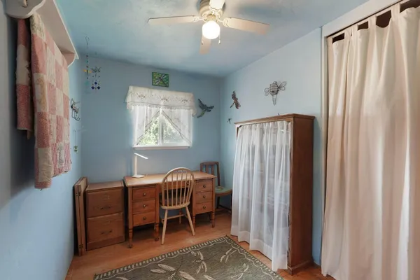 a bedroom with furniture and a window