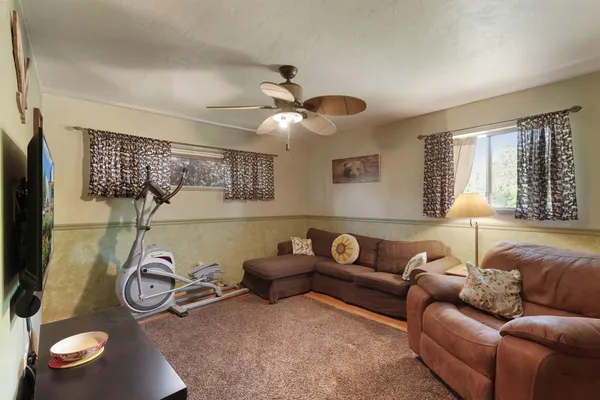 a living room with furniture a chandelier and a window