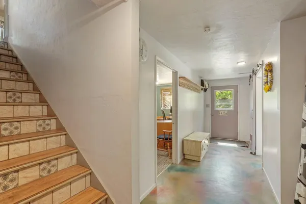 a view of a hallway with seating area