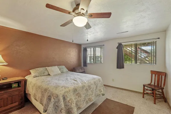 a bedroom with a bed and a chandelier