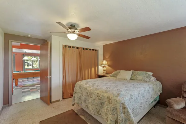 a bedroom with a bed and a chandelier