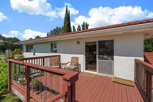 a view of a balcony with wooden floor and fence