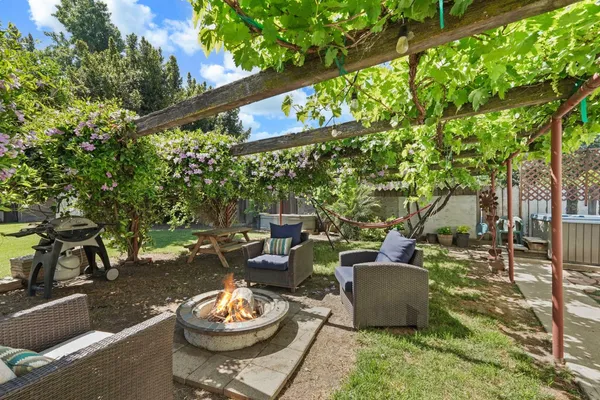 a living room with patio furniture and a potted plant