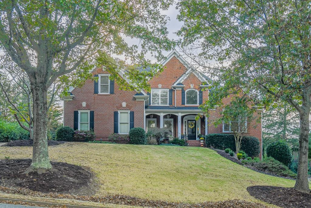 a front view of a house with garden