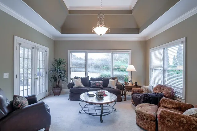 a bedroom with a bed and a large window