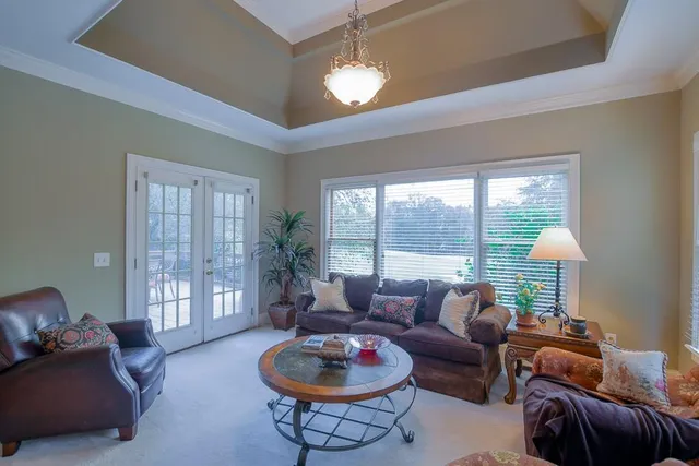 a bathroom with a toilet sink vanity granite and shower