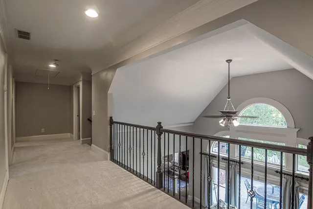 a living room with furniture a ceiling fan and a window