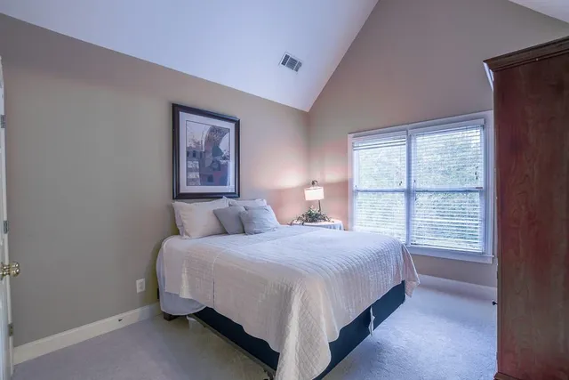 a bedroom with furniture and a lamp