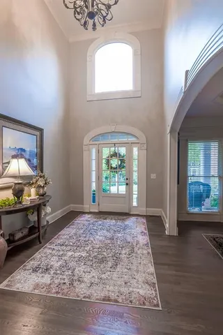a view of a dining room with furniture and chandelier