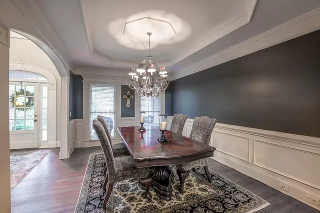 a view of a dining room with furniture and chandelier