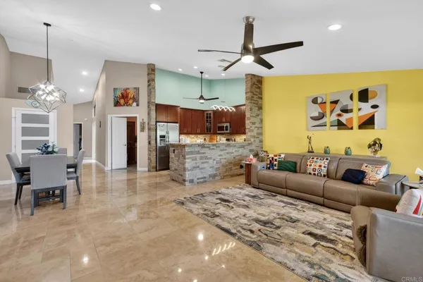 a living room with furniture and kitchen view
