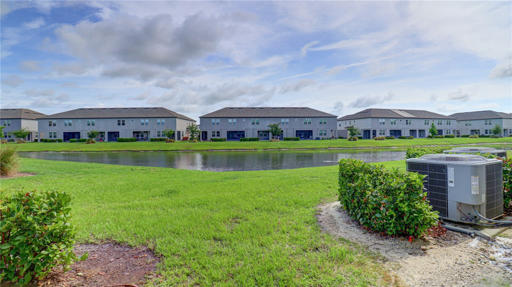 31632 Blue Passing Loop Wesley Chapel, FL 33545 - Photo 46 of 48 a view of a big house with a big yard and large trees