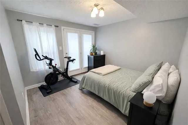 a bedroom with double bed and a chandelier