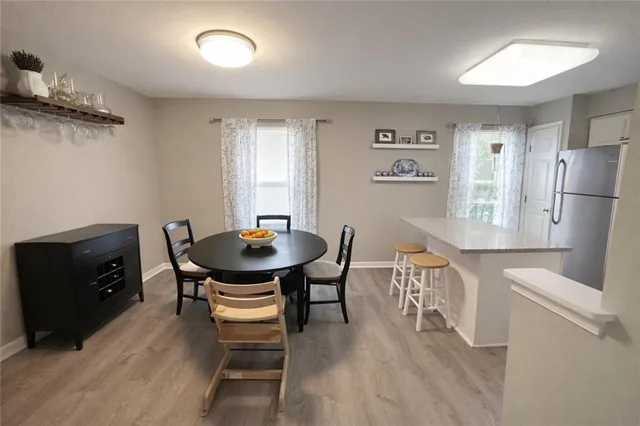 a view of a dining room with furniture and wooden floor