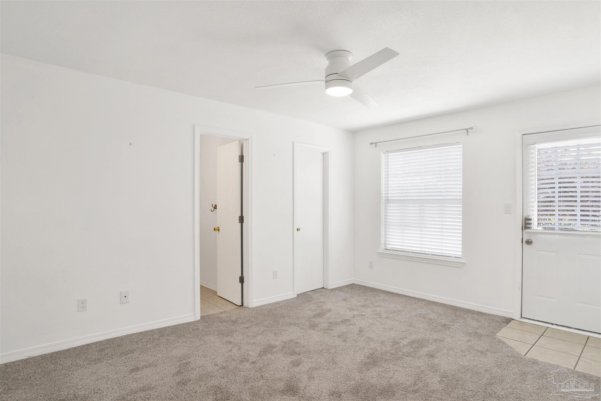 3437 Riverside Drive Pensacola, FL 32514 - Photo 13 of 27 an empty room with windows and fan