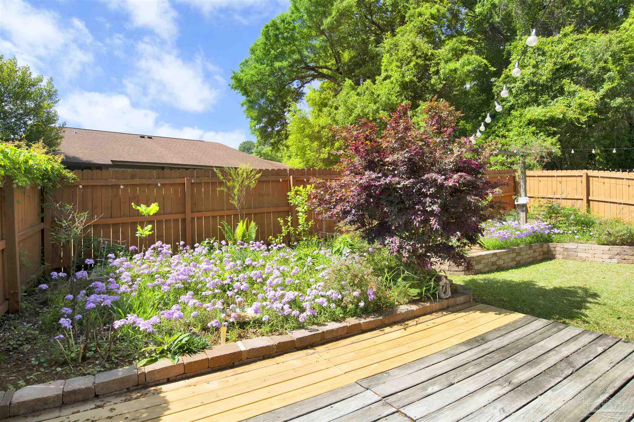 3437 Riverside Drive Pensacola, FL 32514 - Photo 20 of 27 a small garden covered with wooden fence