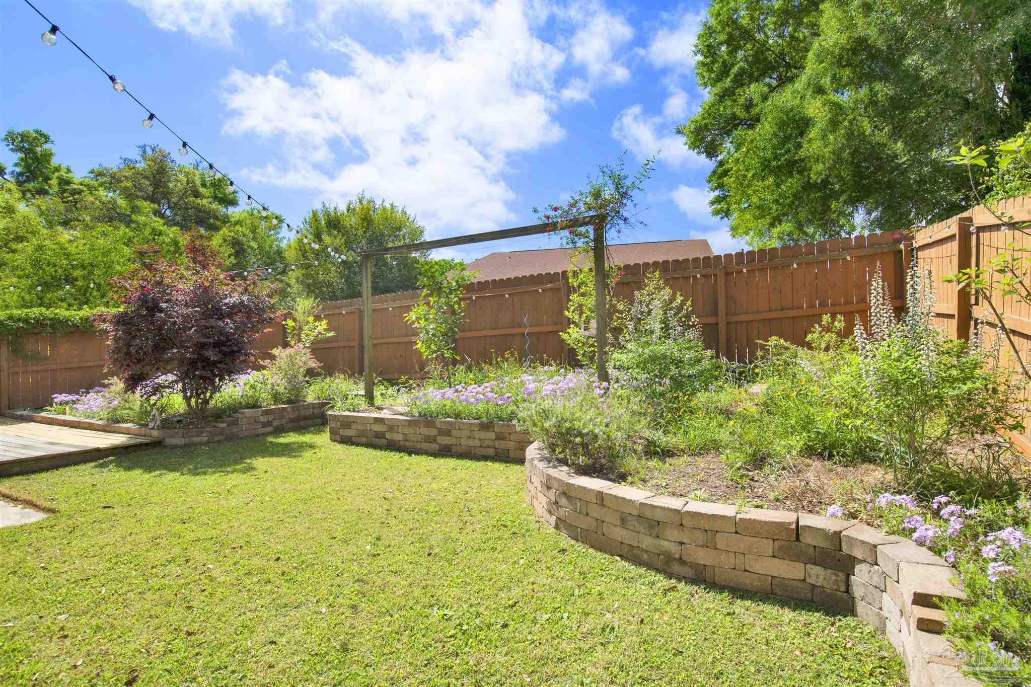 3437 Riverside Drive Pensacola, FL 32514 - Photo 23 of 27 a front view of a house with garden