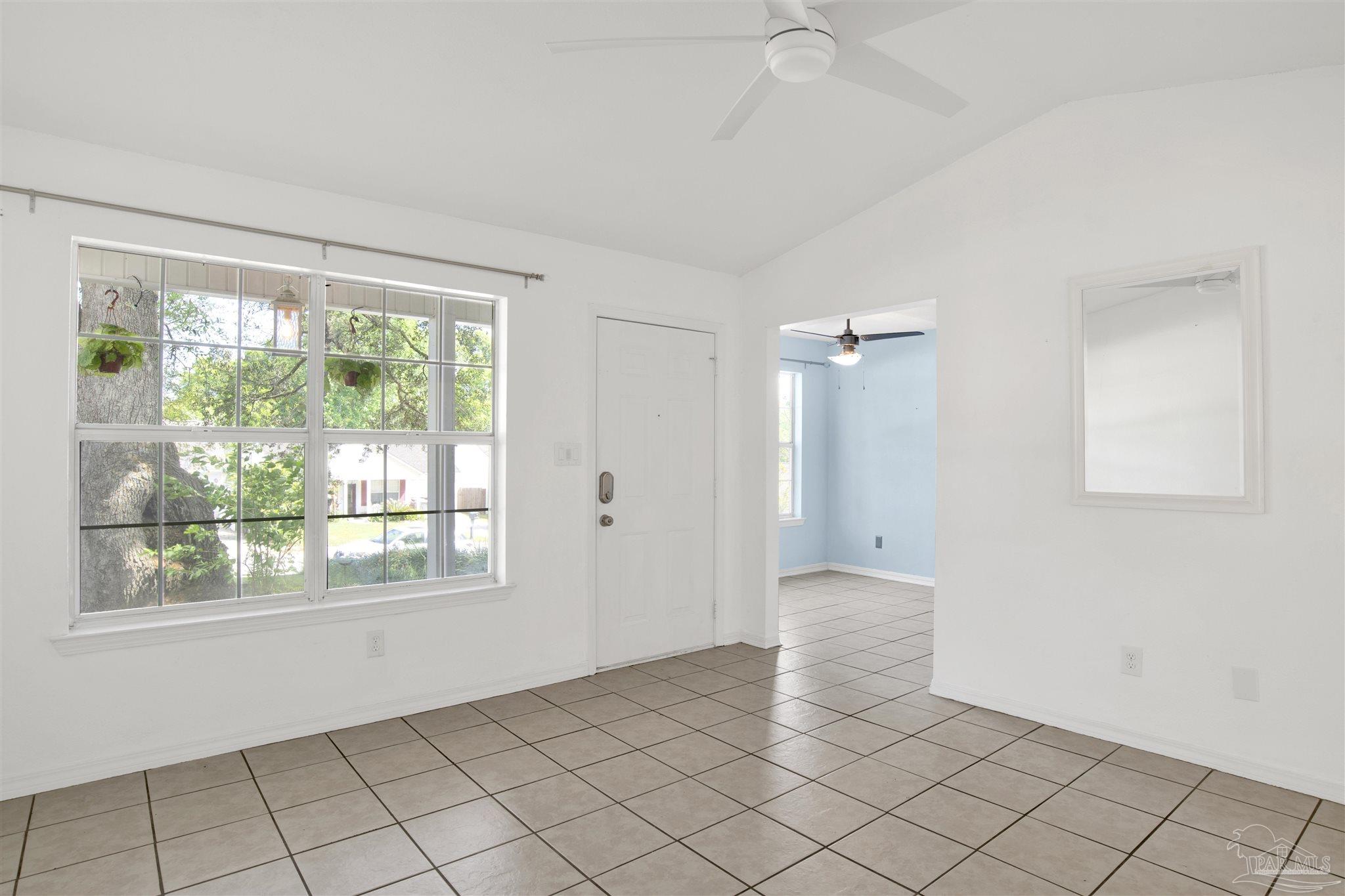 3437 Riverside Drive Pensacola, FL 32514 - Photo 6 of 27 wooden floor in an empty room with a window