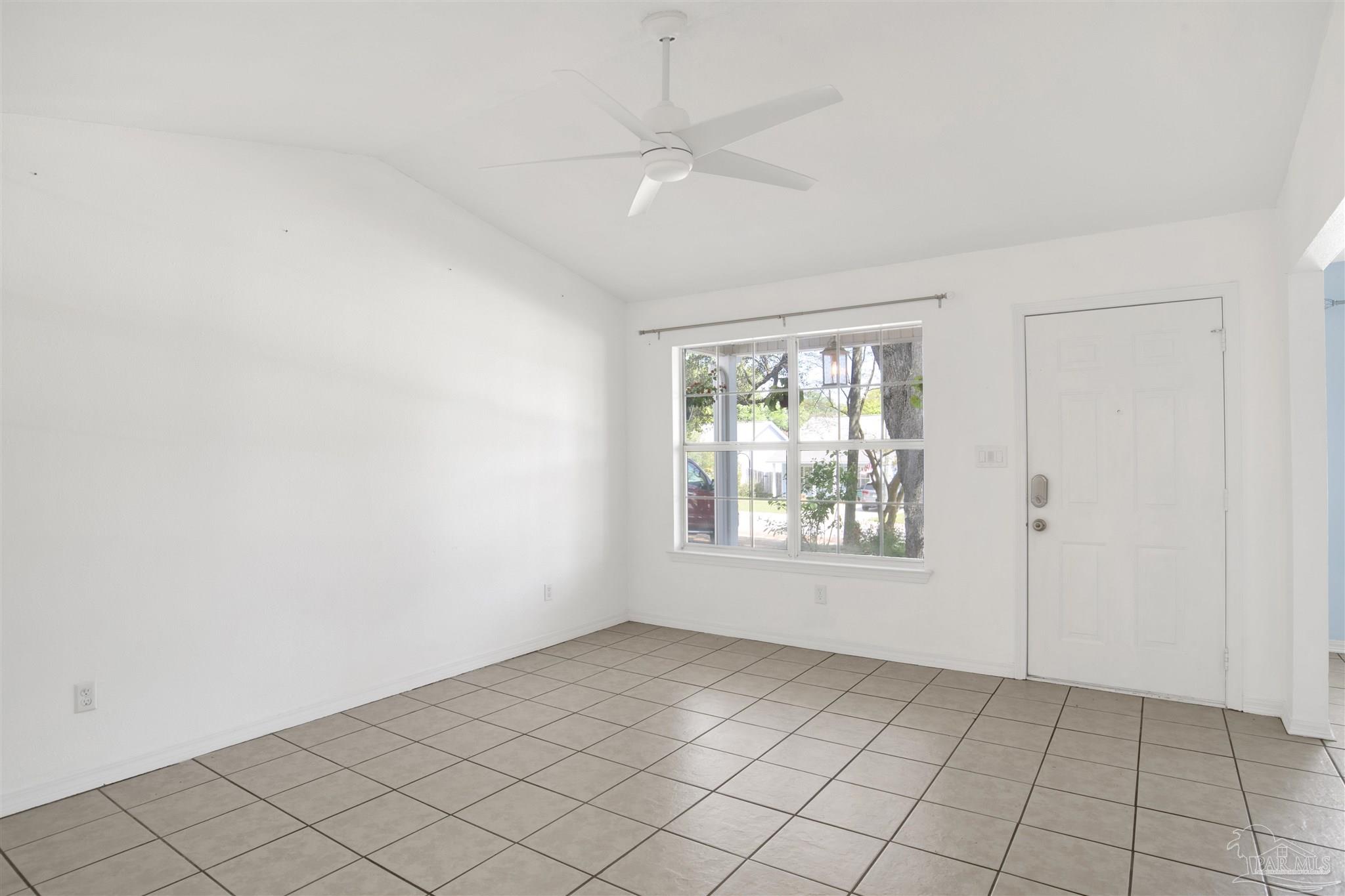 3437 Riverside Drive Pensacola, FL 32514 - Photo 7 of 27 an empty room with windows and fan