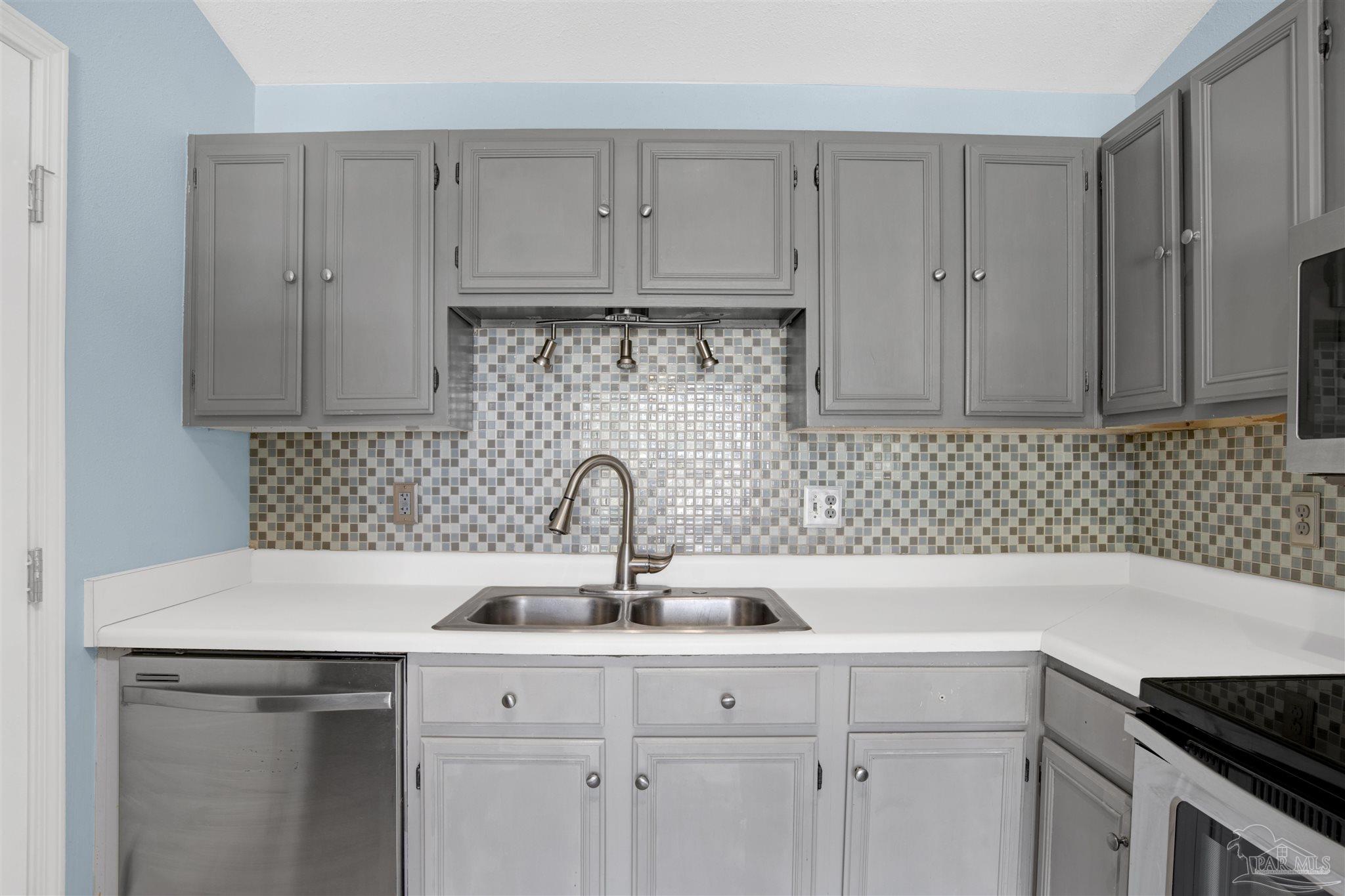 3437 Riverside Drive Pensacola, FL 32514 - Photo 10 of 27 a kitchen with a sink and cabinets