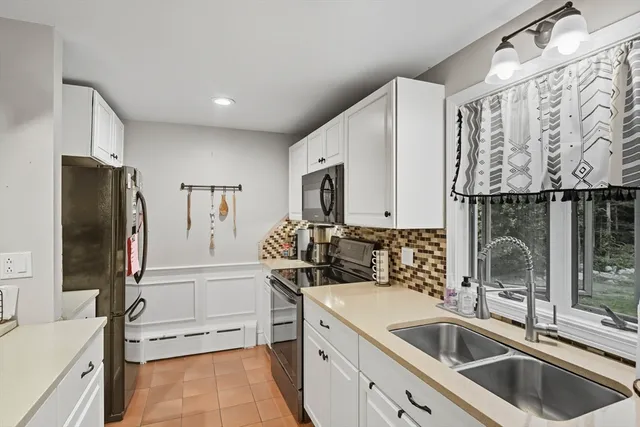 a kitchen with stainless steel appliances a sink stove and refrigerator
