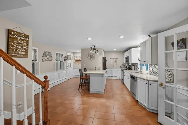 a kitchen with stainless steel appliances kitchen island cabinets and a sink