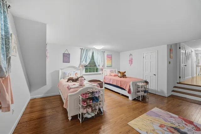 a bedroom with furniture and a wooden floor