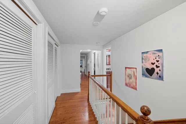 a view of a hallway with paintings on the wall