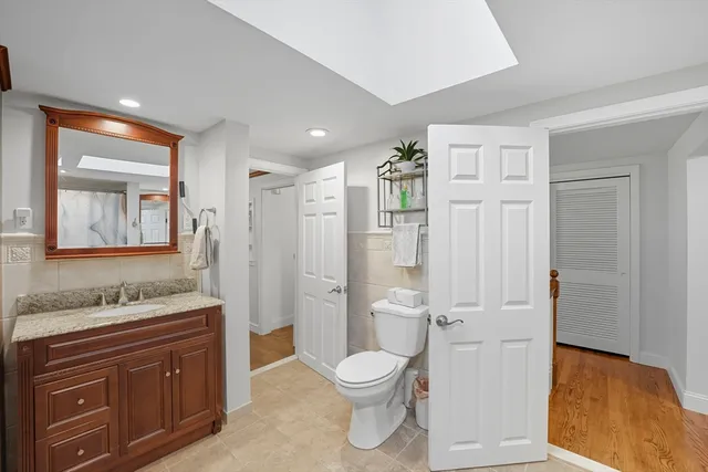 a bathroom with a toilet a sink and a mirror