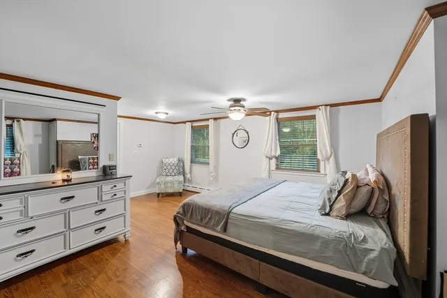 a bedroom with a bed and a large mirror on dresser
