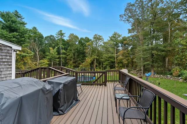a view of a balcony with wooden floor and fence