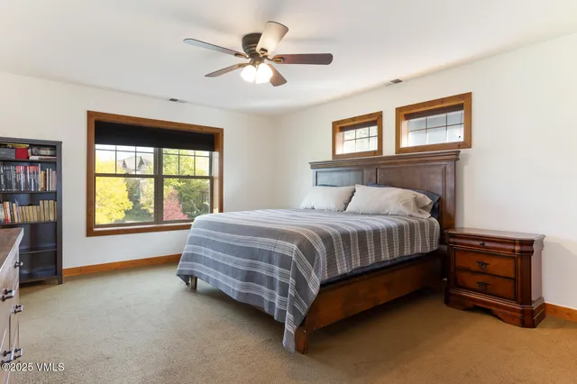 a bedroom with a bed dresser and a window