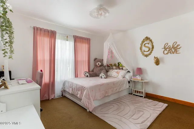 a bedroom with a bed and a table in it