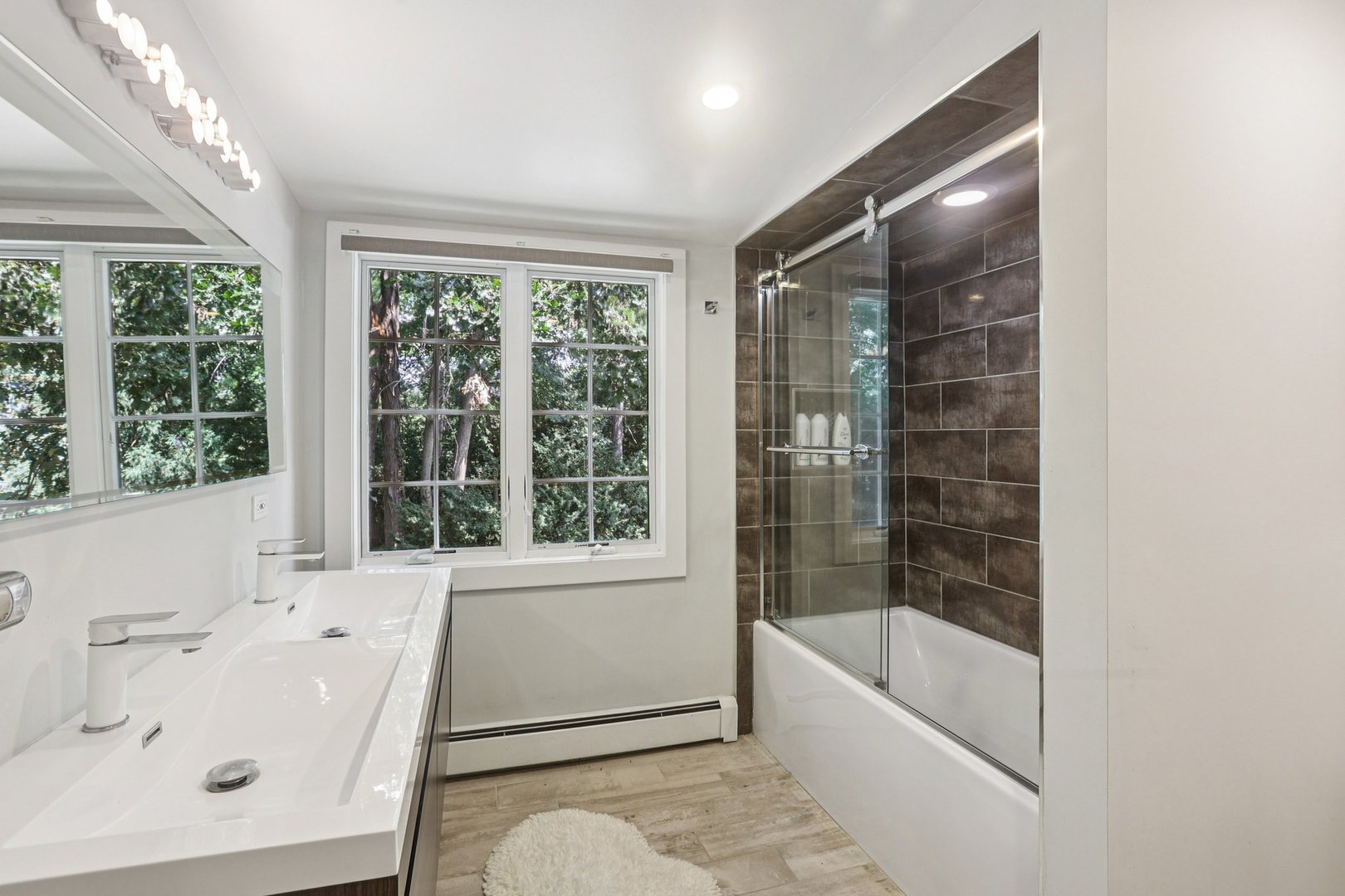 1834 West Palatine Road Palatine, IL 60067 - Photo 29 of 56 a bathroom with a bathtub a sink and a large window with garden view