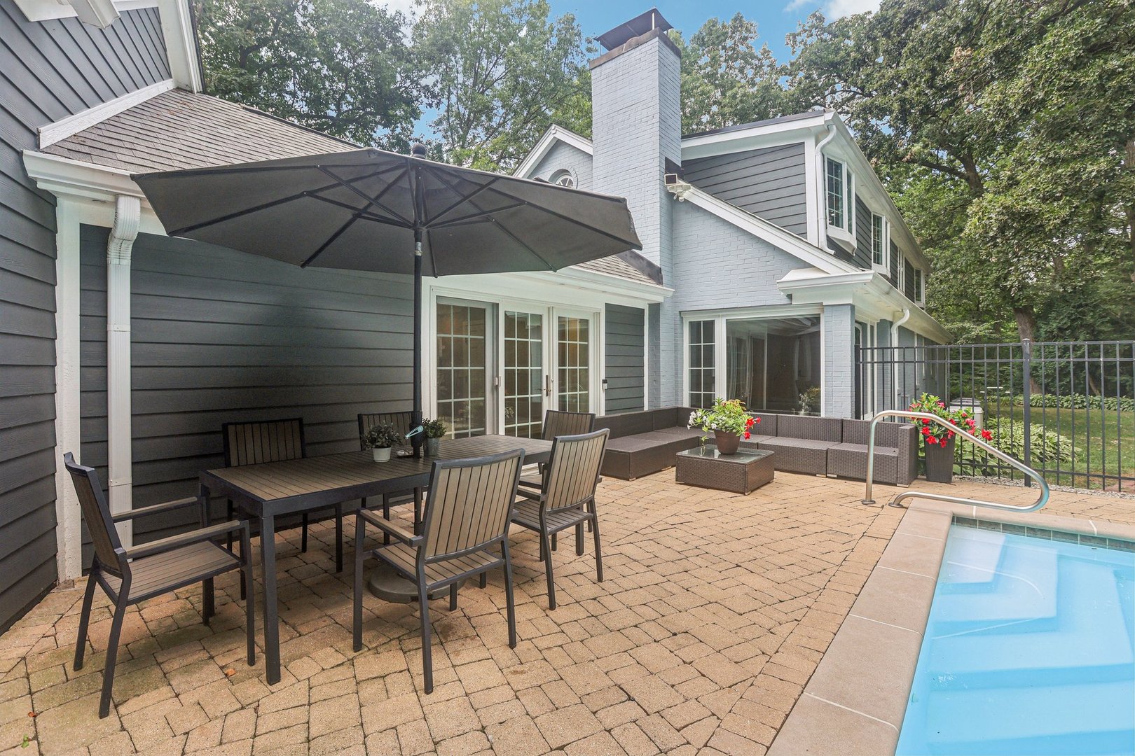 1834 West Palatine Road Palatine, IL 60067 - Photo 44 of 56 a view of a patio with a dining table and chairs under an umbrella