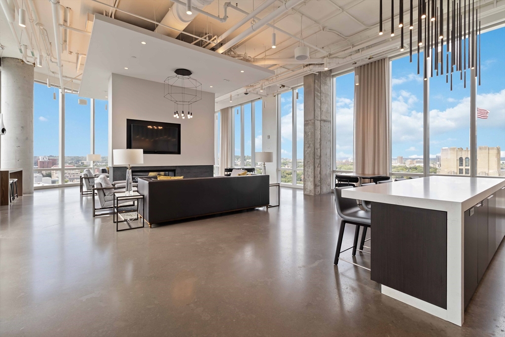 188 Brookline Avenue, Unit 20J Boston, MA 02215 - Photo 24 of 28 a living room with furniture a flat screen tv and a large window