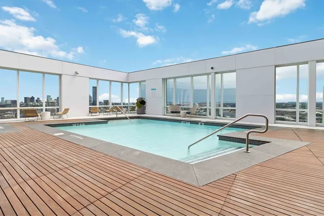 a living room with kitchen island furniture and a view of kitchen