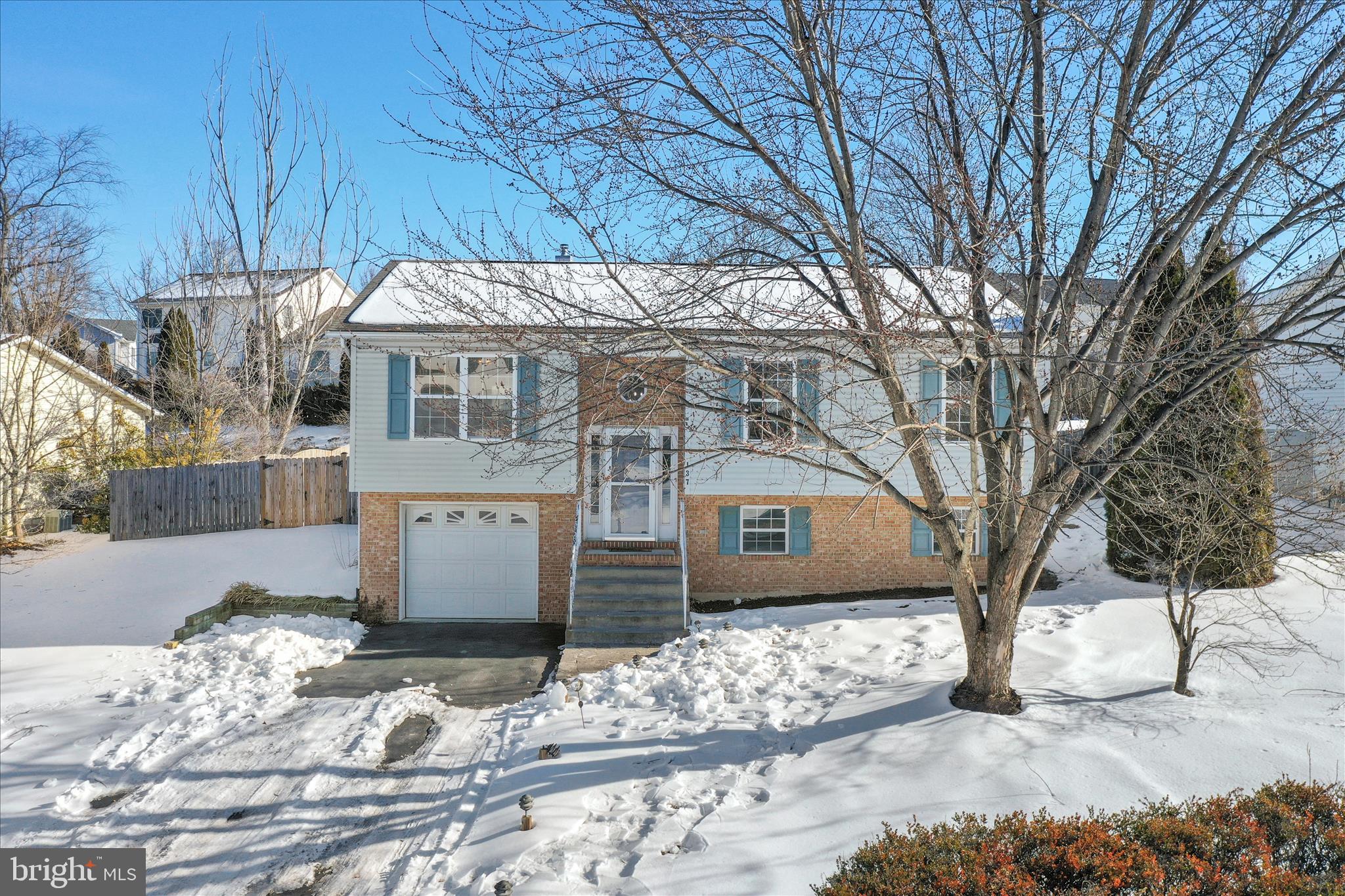 a view of a house with a snow in the yard