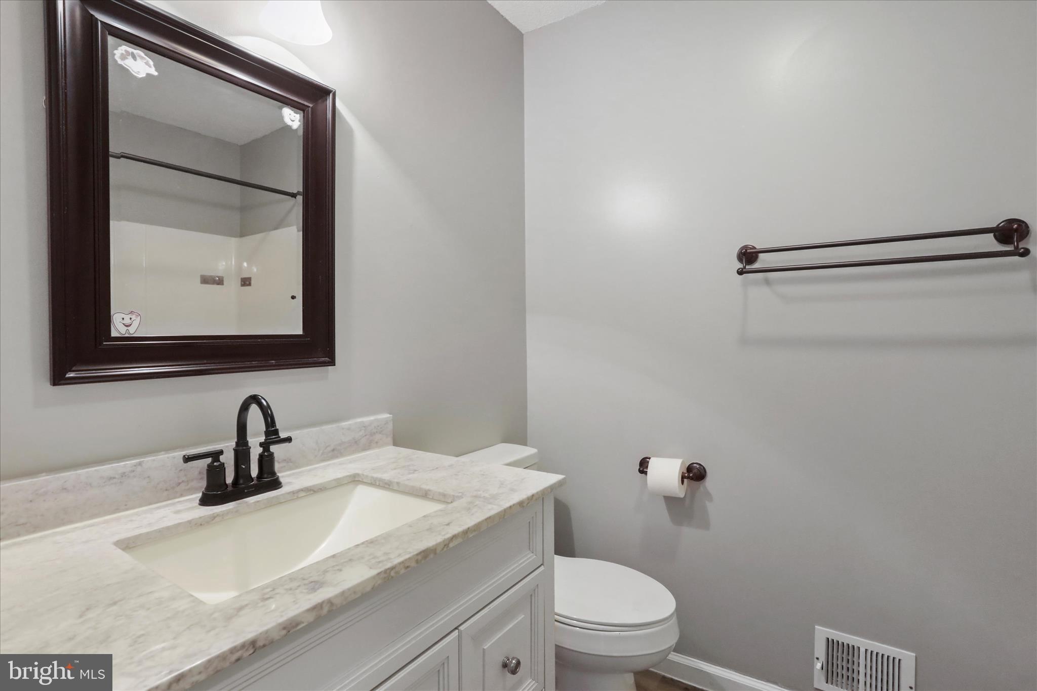137 Woodrow Road Winchester, VA 22602 - Photo 13 of 45 a bathroom with a toilet sink and mirror
