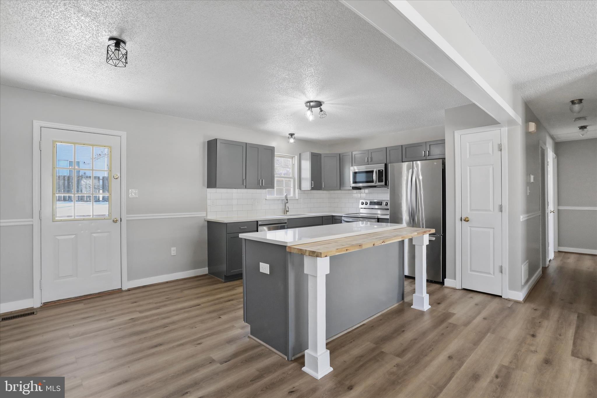 137 Woodrow Road Winchester, VA 22602 - Photo 16 of 45 a kitchen with a stove top oven and refrigerator