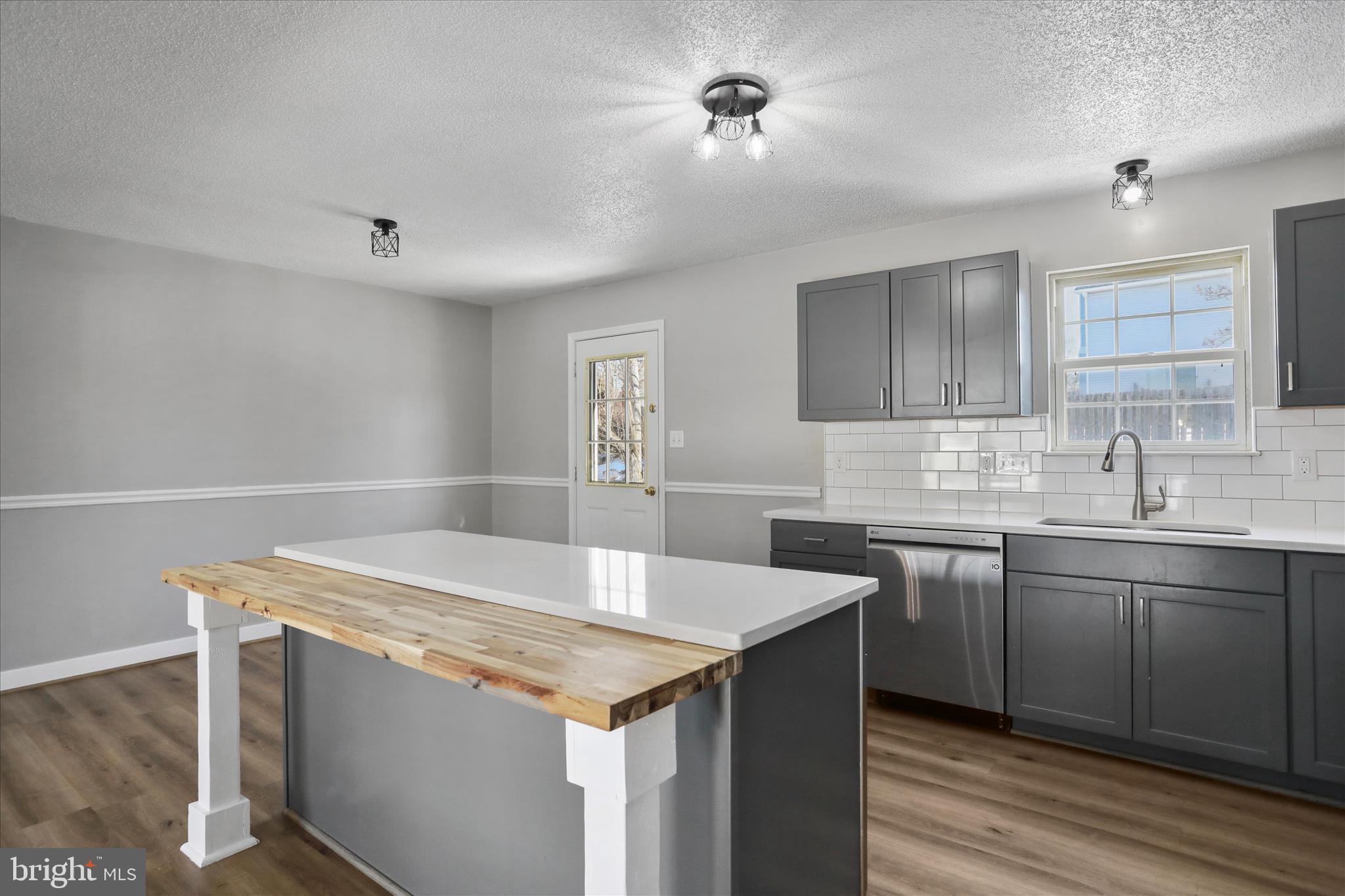 137 Woodrow Road Winchester, VA 22602 - Photo 17 of 45 a kitchen with granite countertop a sink and stove