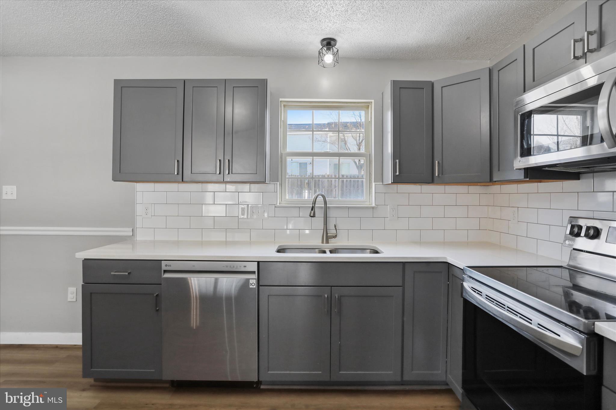 137 Woodrow Road Winchester, VA 22602 - Photo 18 of 45 a kitchen with stainless steel appliances granite countertop a sink stove and cabinets