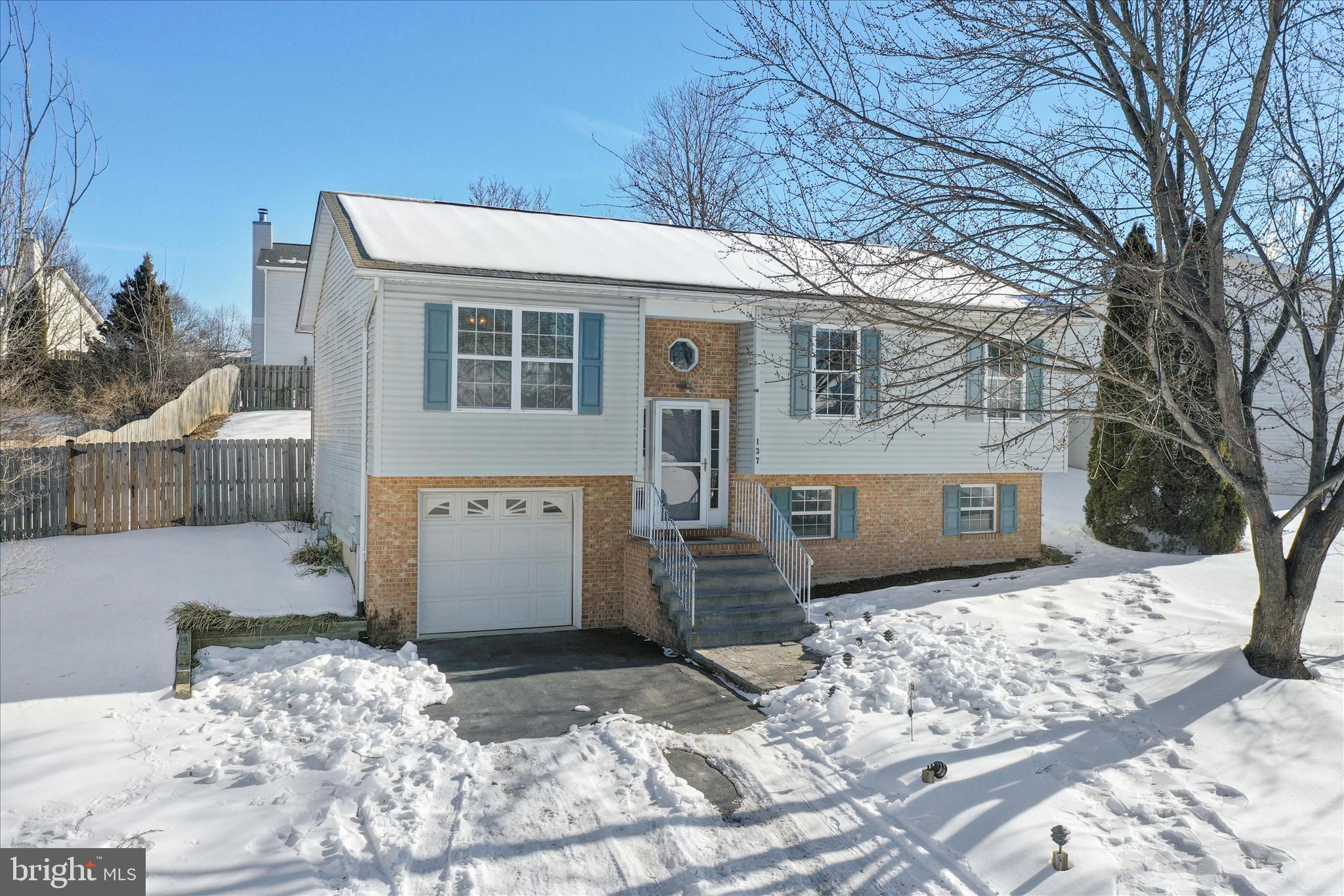 137 Woodrow Road Winchester, VA 22602 - Photo 2 of 45 a view of a house with a yard covered in snow