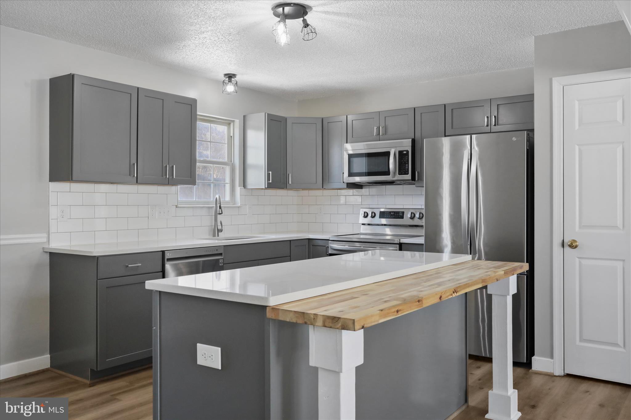 137 Woodrow Road Winchester, VA 22602 - Photo 24 of 45 a kitchen with stainless steel appliances a refrigerator sink and microwave